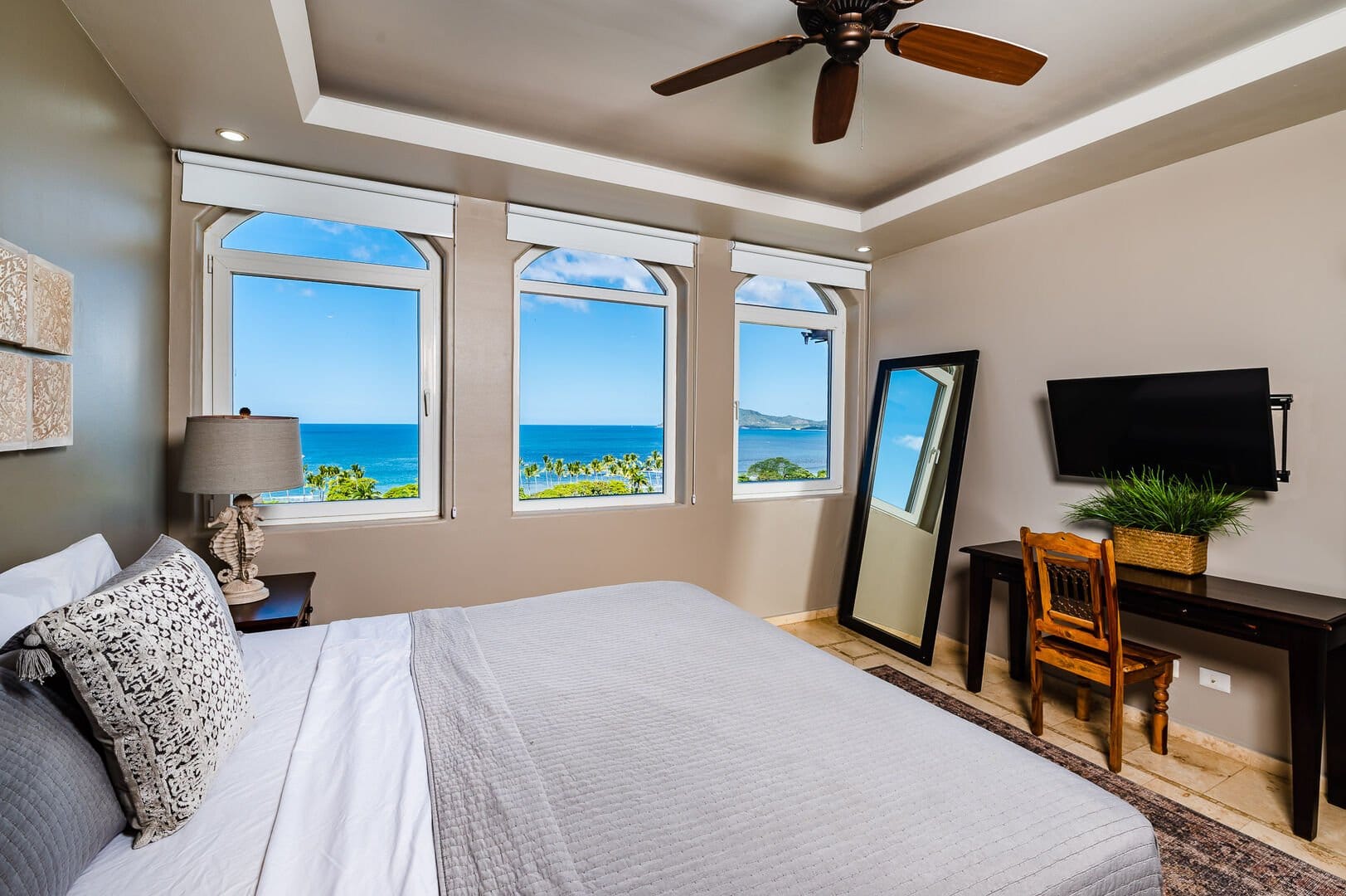 Bedroom with ocean view windows.