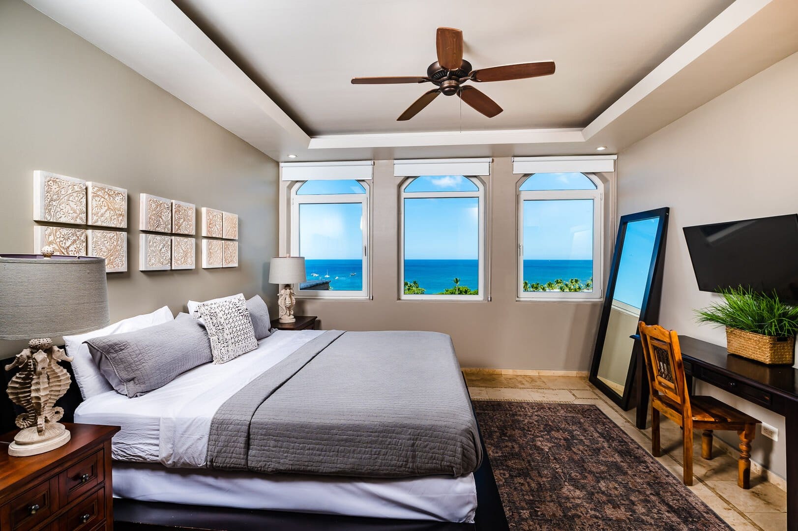 Coastal-themed bedroom with ocean view.