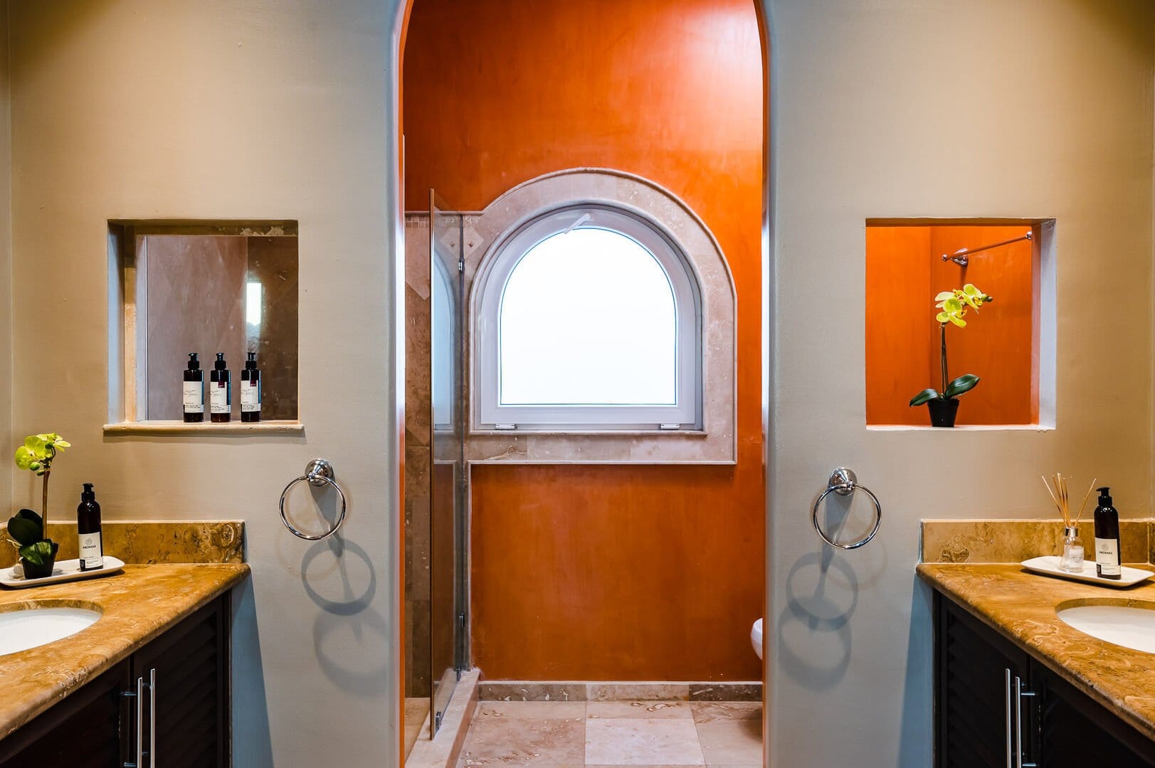 Modern bathroom with orange accents.