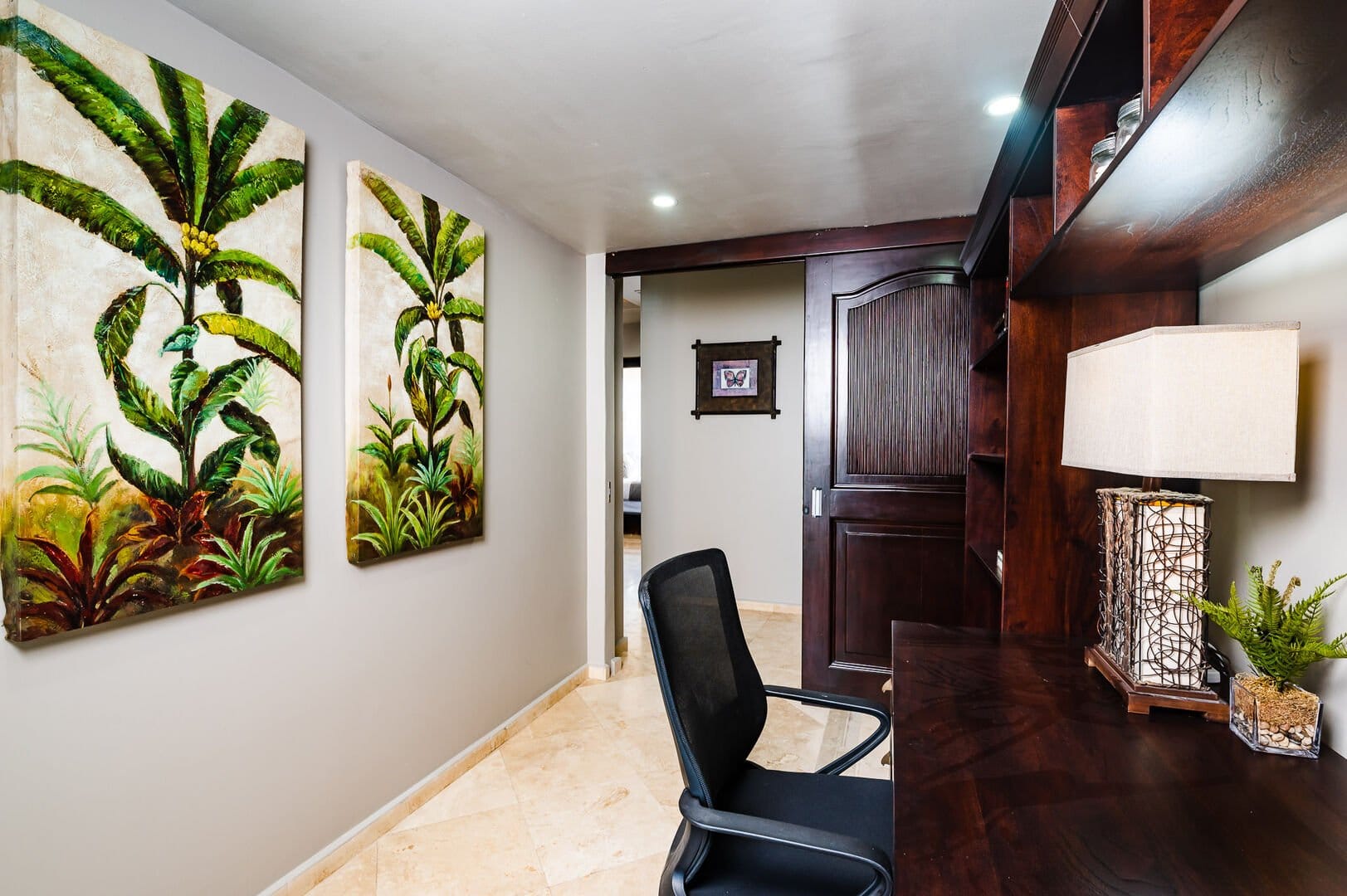 Home office with tropical paintings.