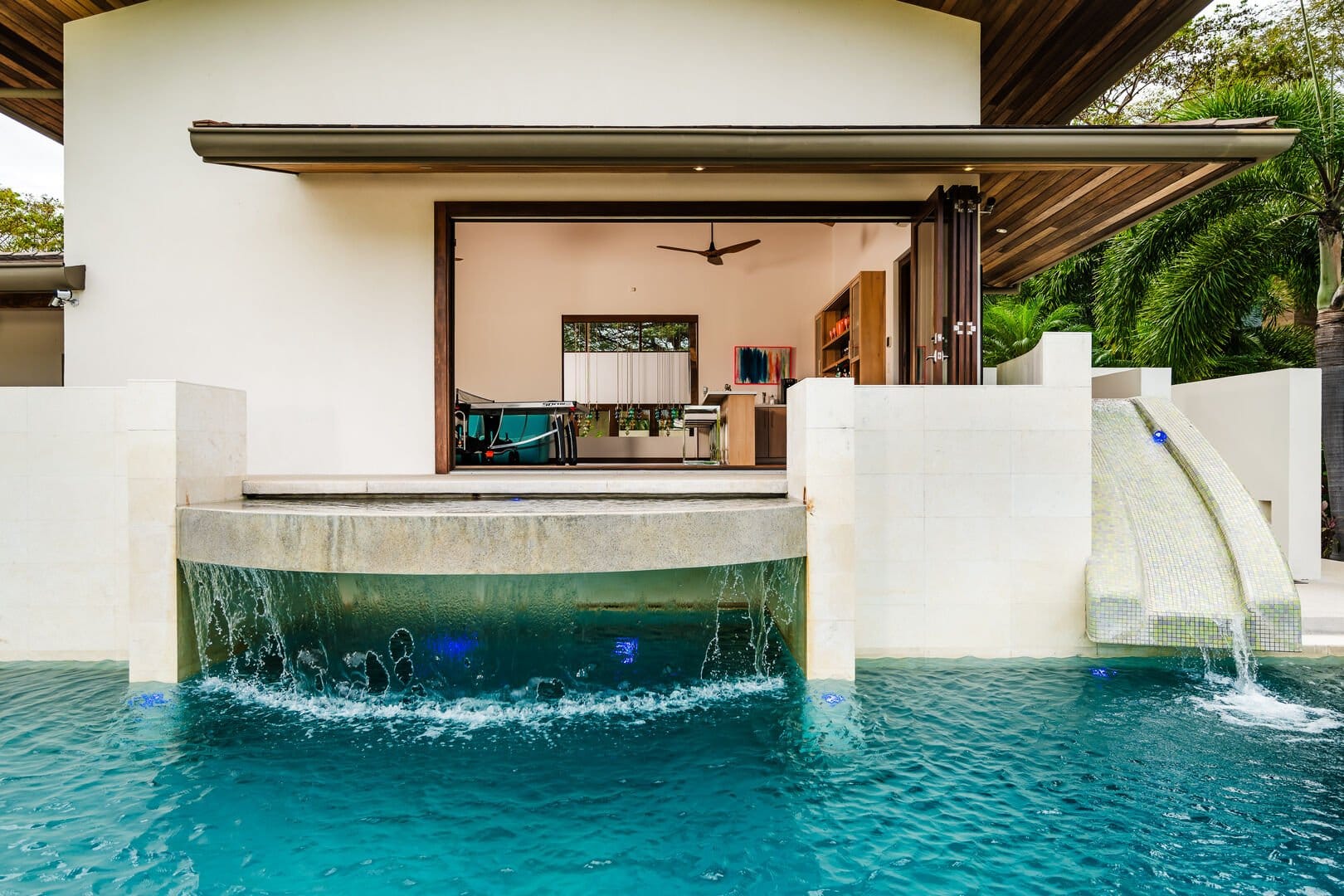 House with pool and waterfall.