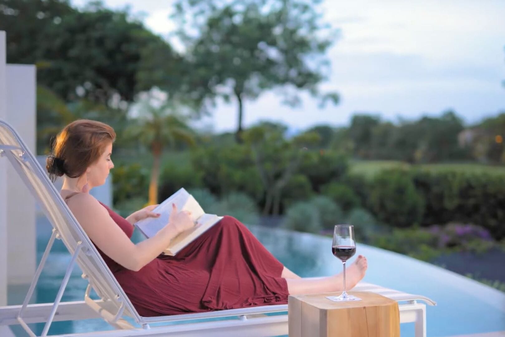 Woman reading by the pool.