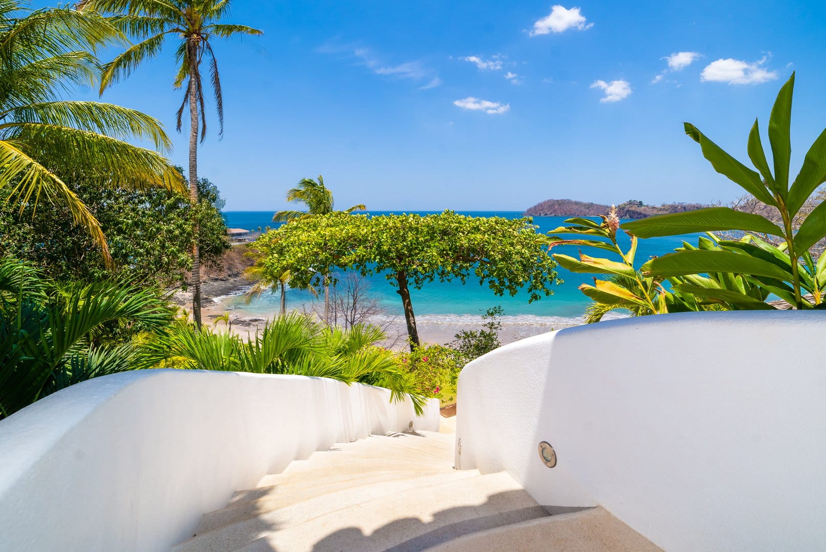 White stairs lead to beach.