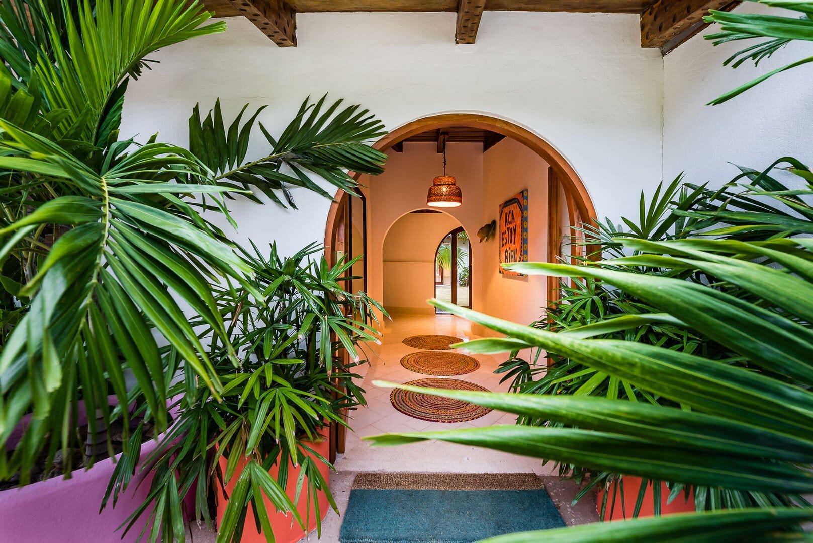 Arched entrance with lush plants.
