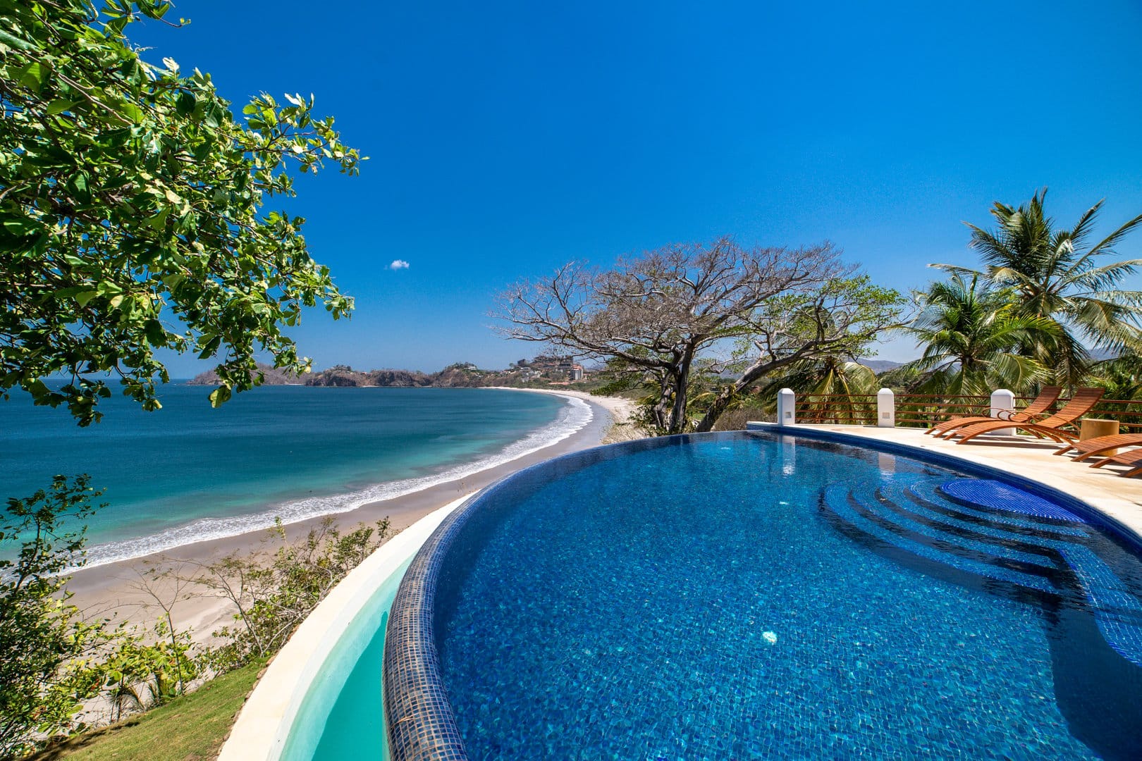 Infinity pool overlooking ocean beach.