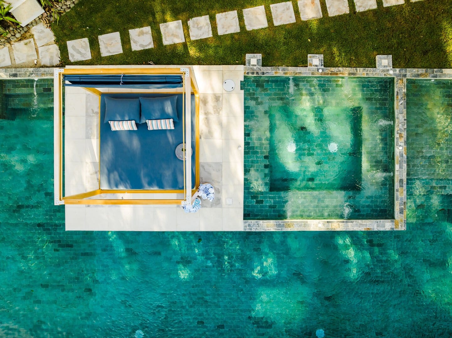 Outdoor poolside cabana with cushions.