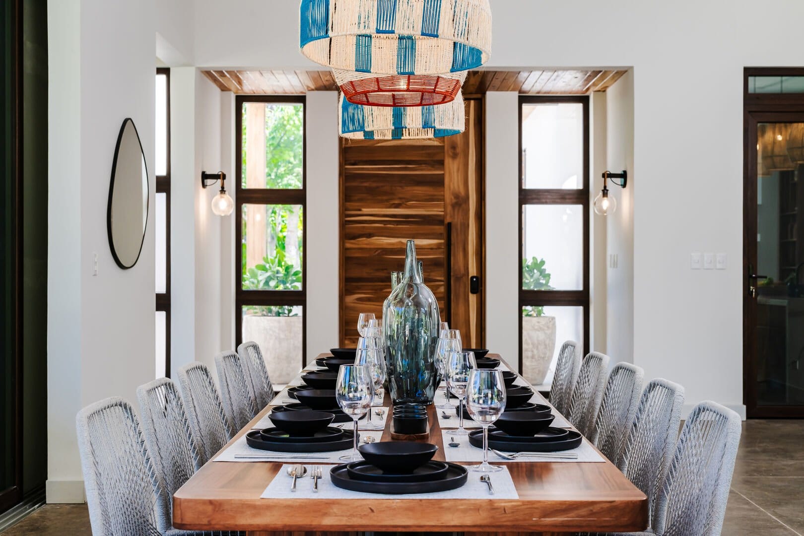 Elegant dining room with colorful chandelier.