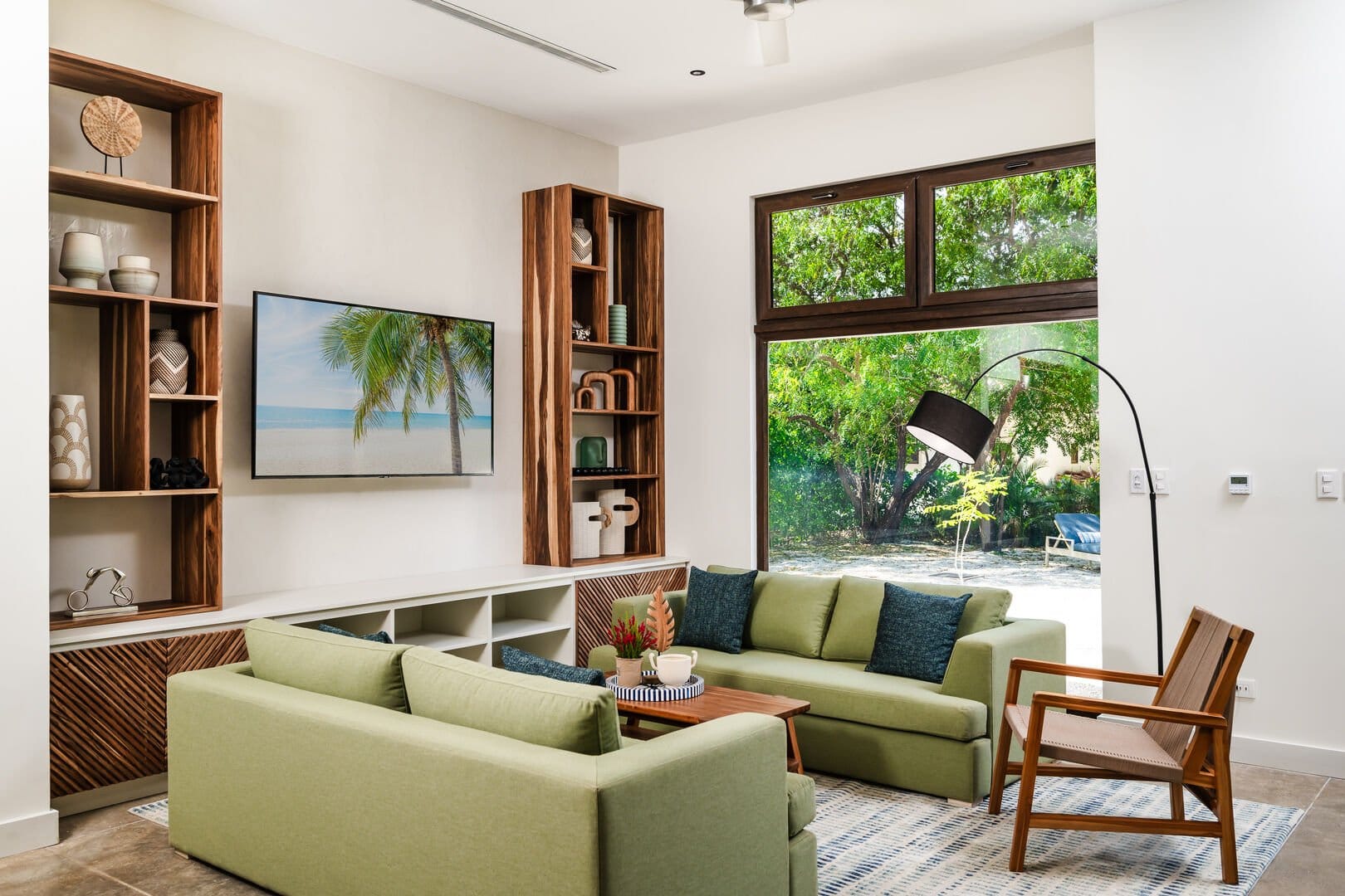 Modern living room with green sofas.