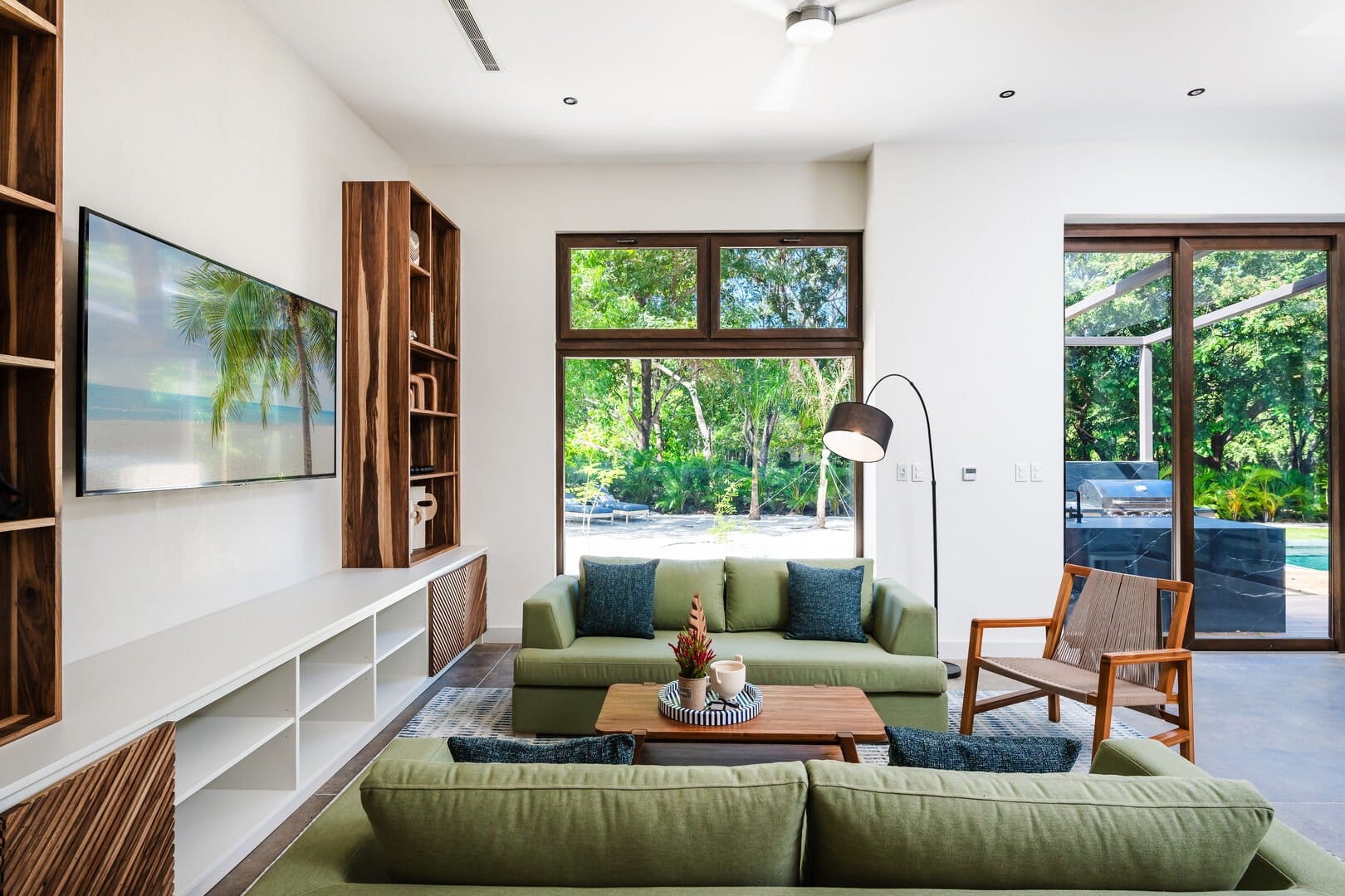 Modern living room with green sofas.