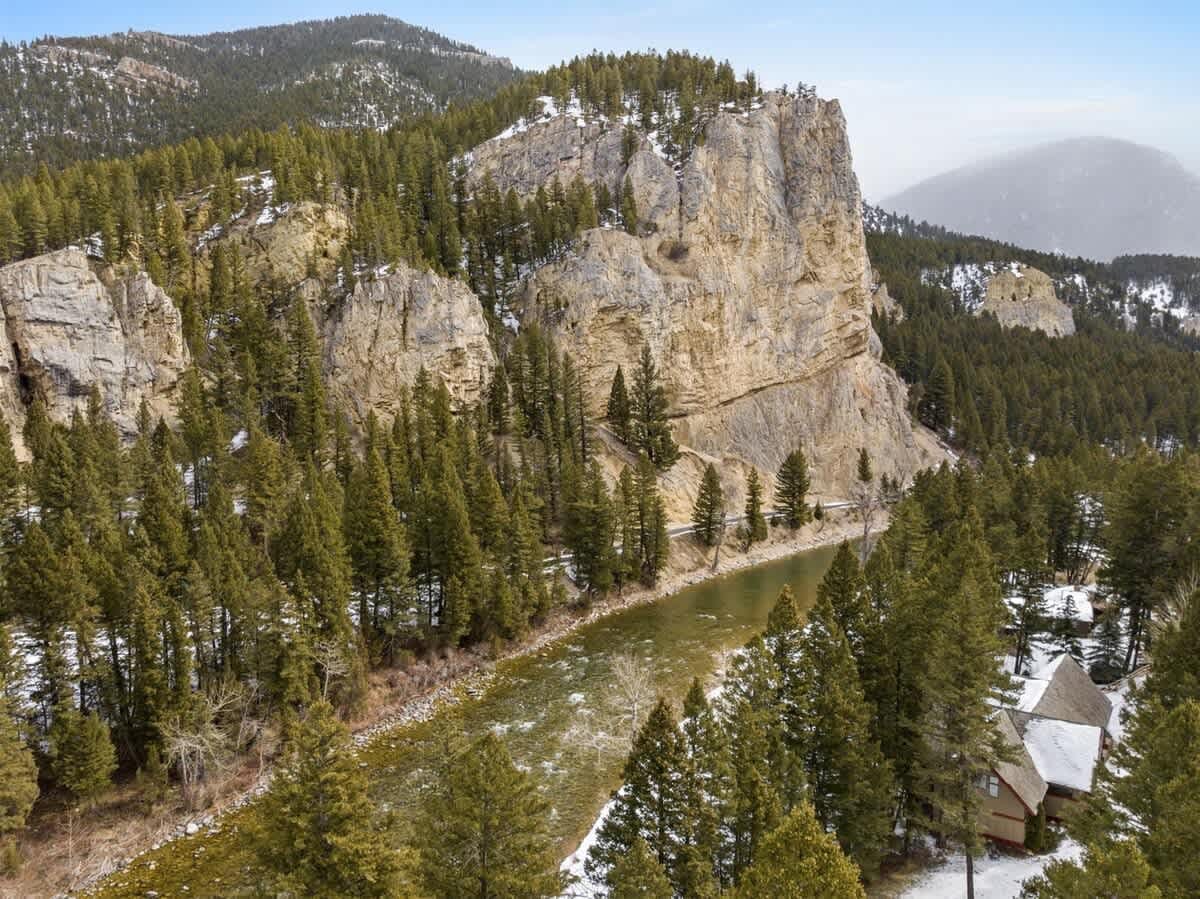 River, forest, snowy cliffs, cabin.