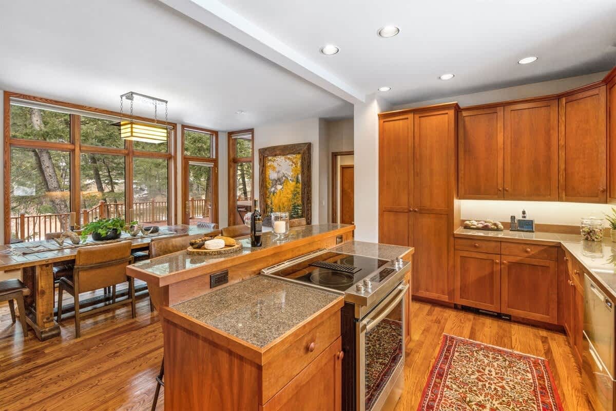 Wooden kitchen with large windows.