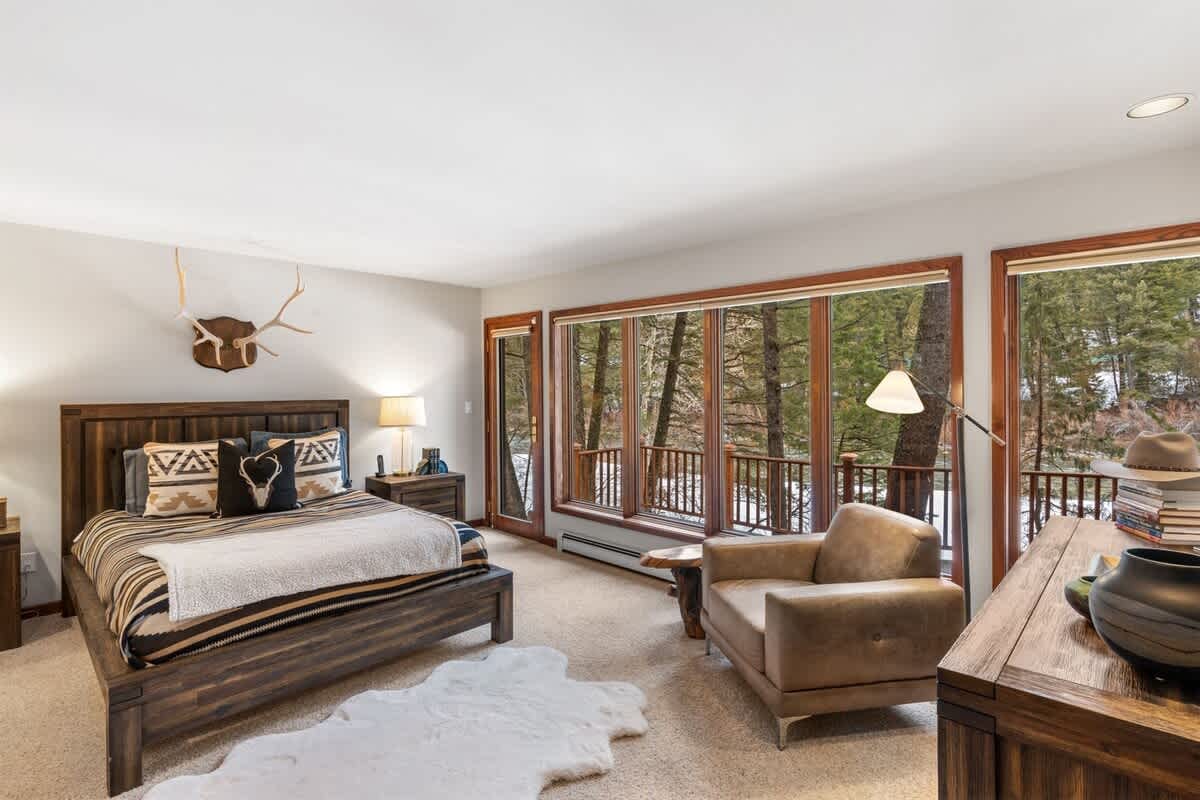 Cozy bedroom with forest view.