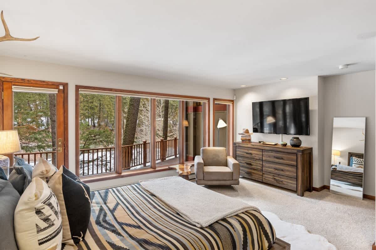 Cozy bedroom with forest view.