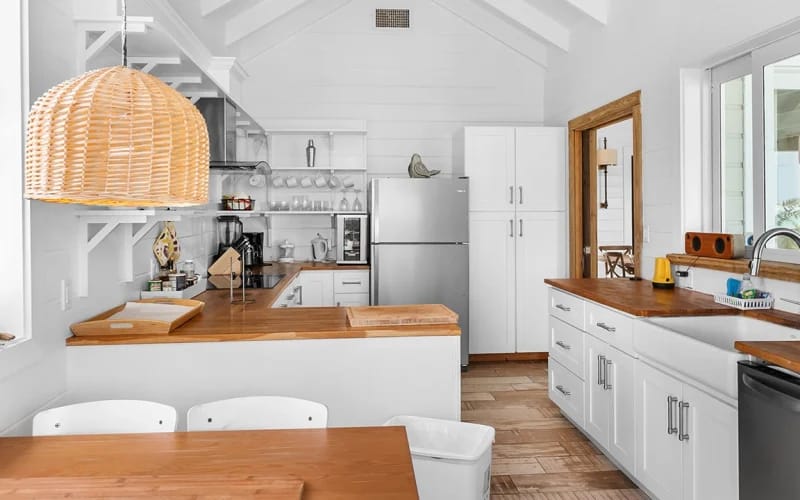 Modern white kitchen with wooden accents.