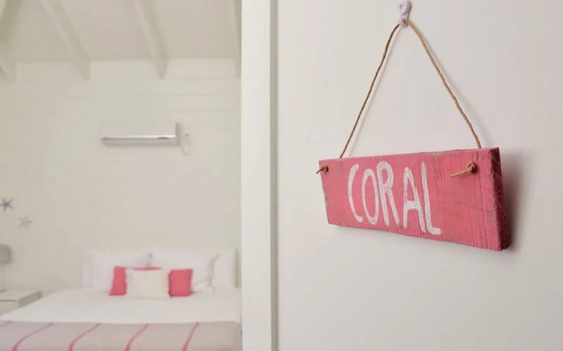 Room sign reading "Coral" on wall.