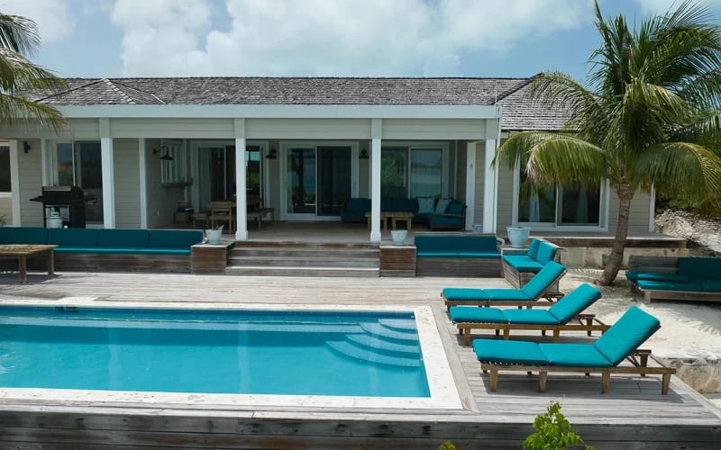 Beachside villa with pool, loungers.