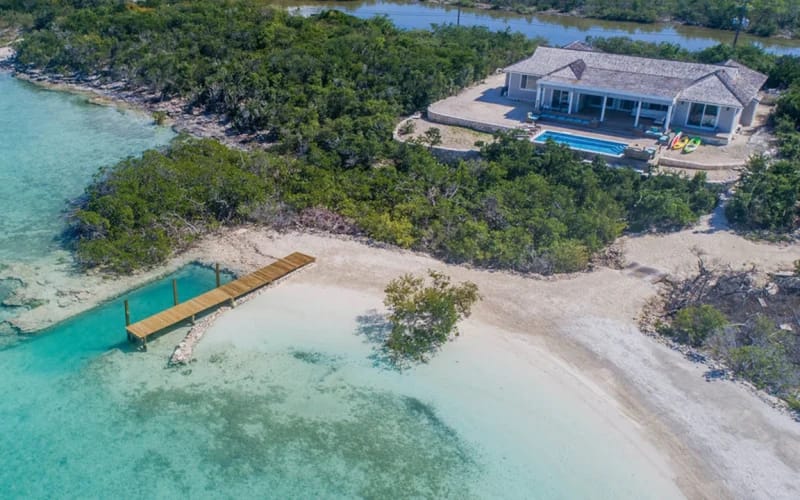 Beachfront house with dock and pool.