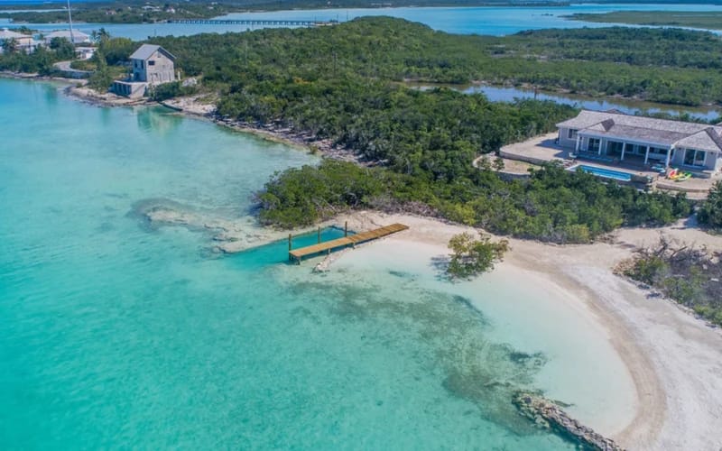 Beachfront house with clear water.