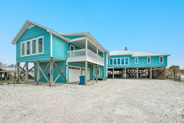 Blue stilt house on beach.