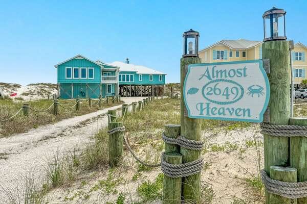 Beach house with "Almost Heaven" sign.