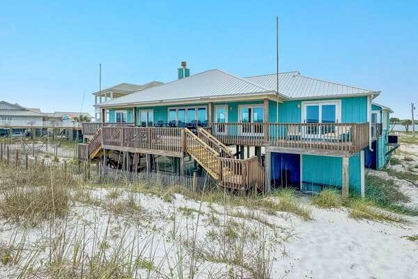 Beachfront house with wooden deck.
