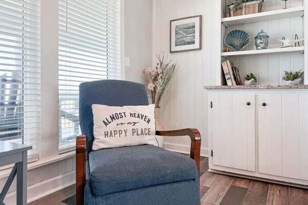 Cozy chair with decorative pillow.