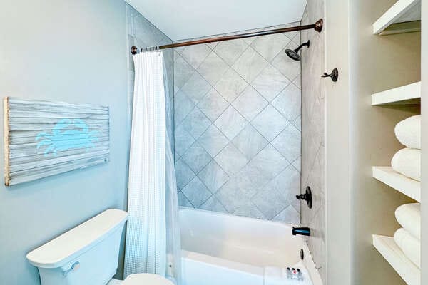 Compact bathroom with shower and bathtub.