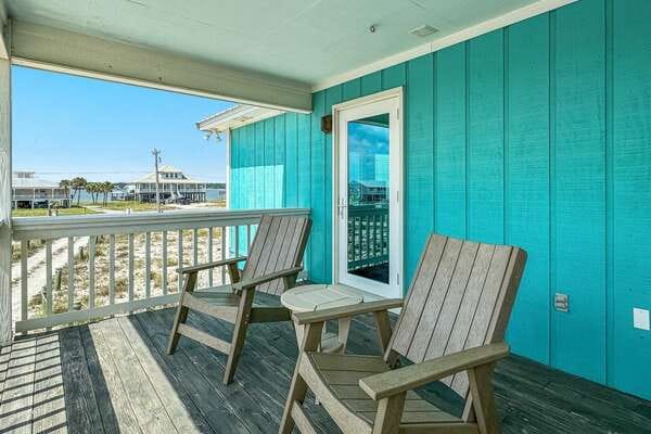 Turquoise porch with two chairs.
