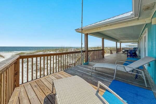 Beach house porch with loungers.