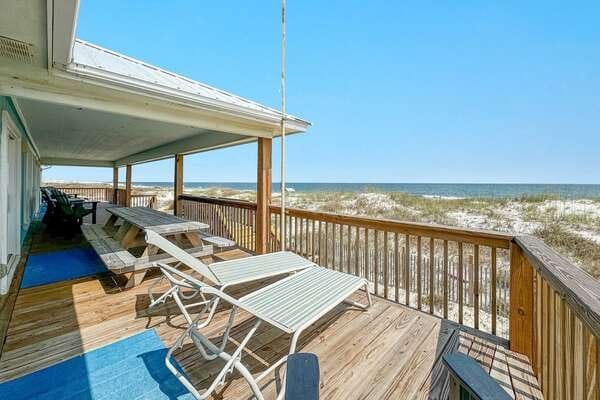 Beachfront deck with lounge chairs.