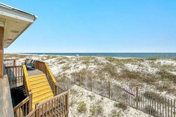Beach view from wooden balcony.
