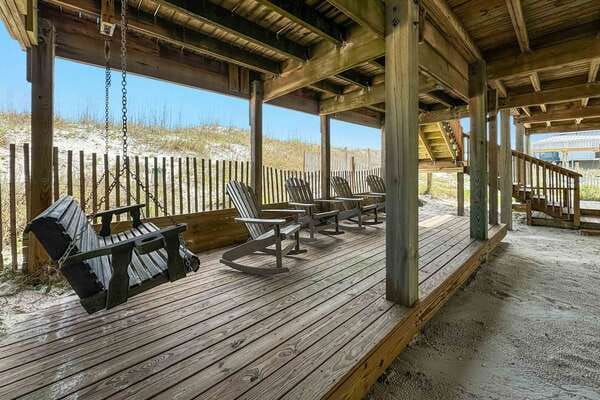 Wooden deck with chairs, swing.