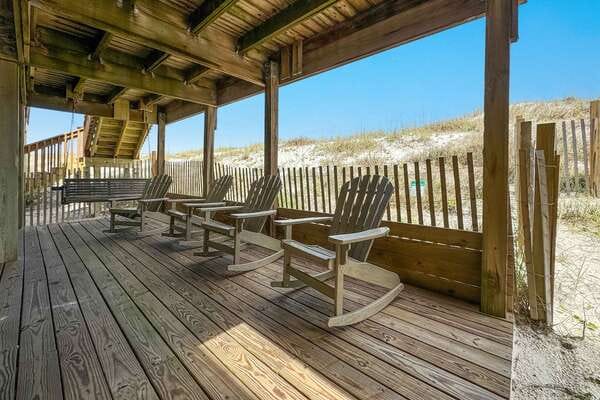 Wooden deck with rocking chairs.