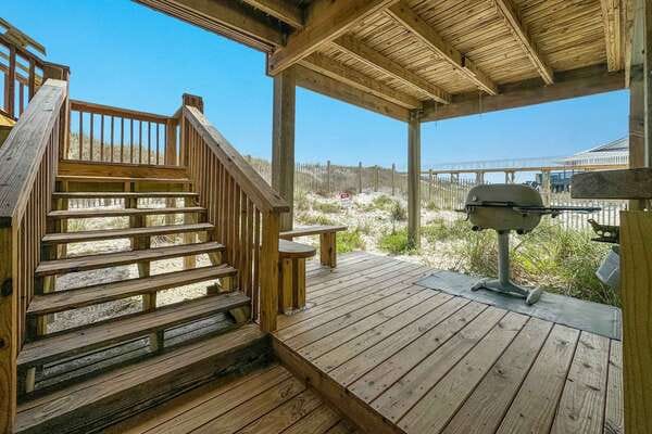 Wooden deck with stairs, grill.