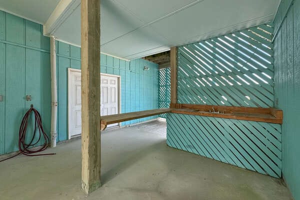 Covered outdoor area with teal walls.