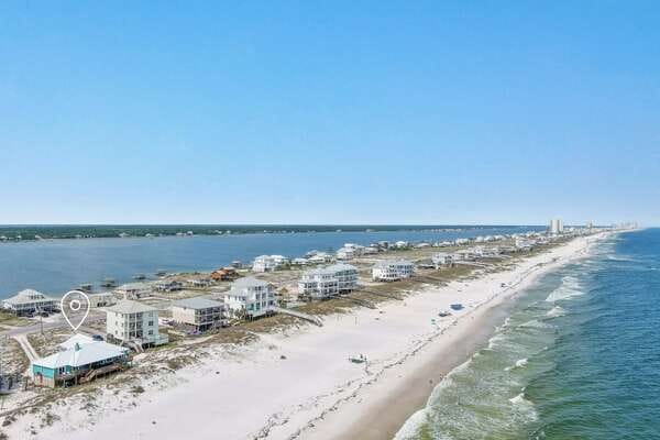 Coastal houses on sandy beach.
