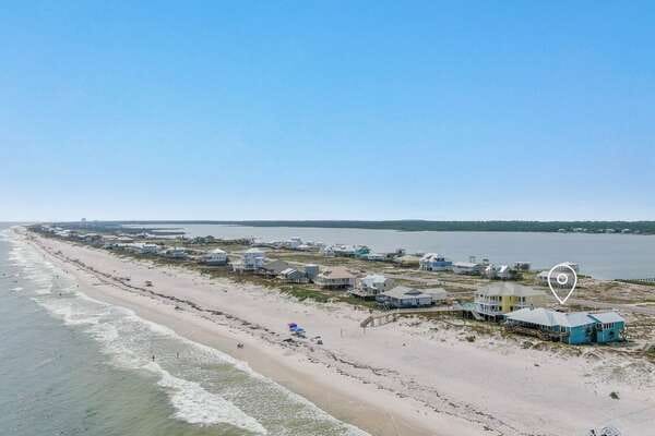 Beachfront houses along sandy coastline.
