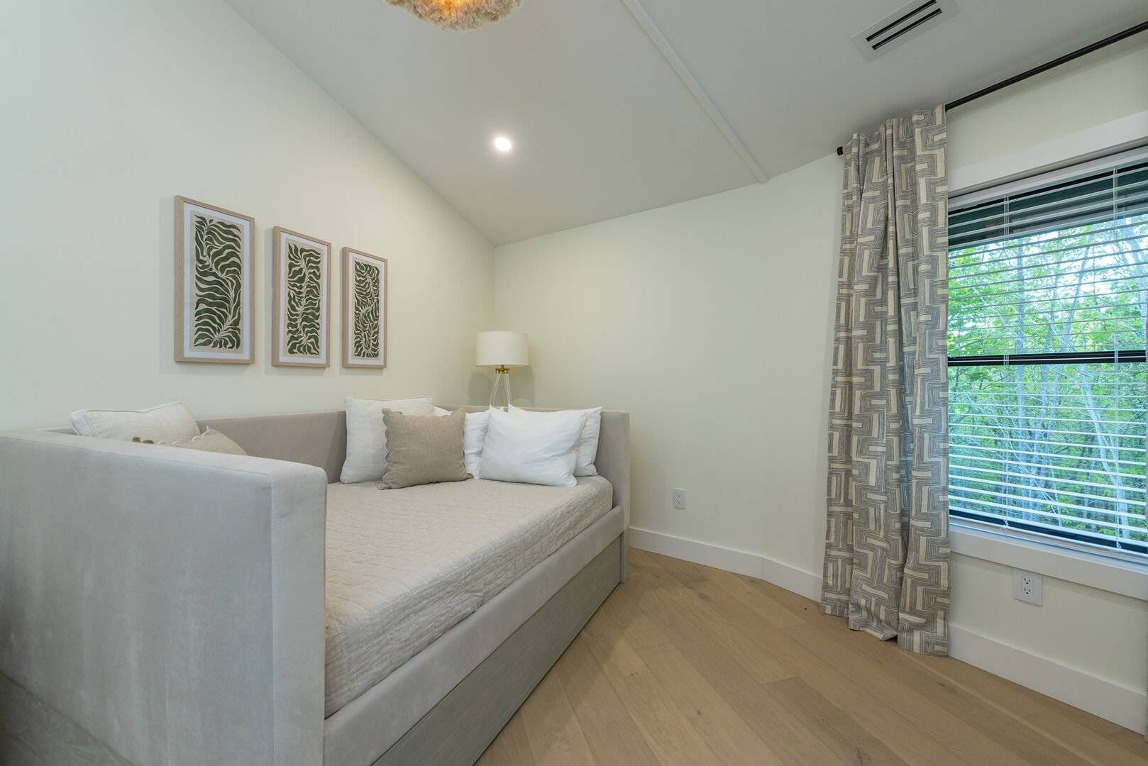 Cozy room with daybed, window.