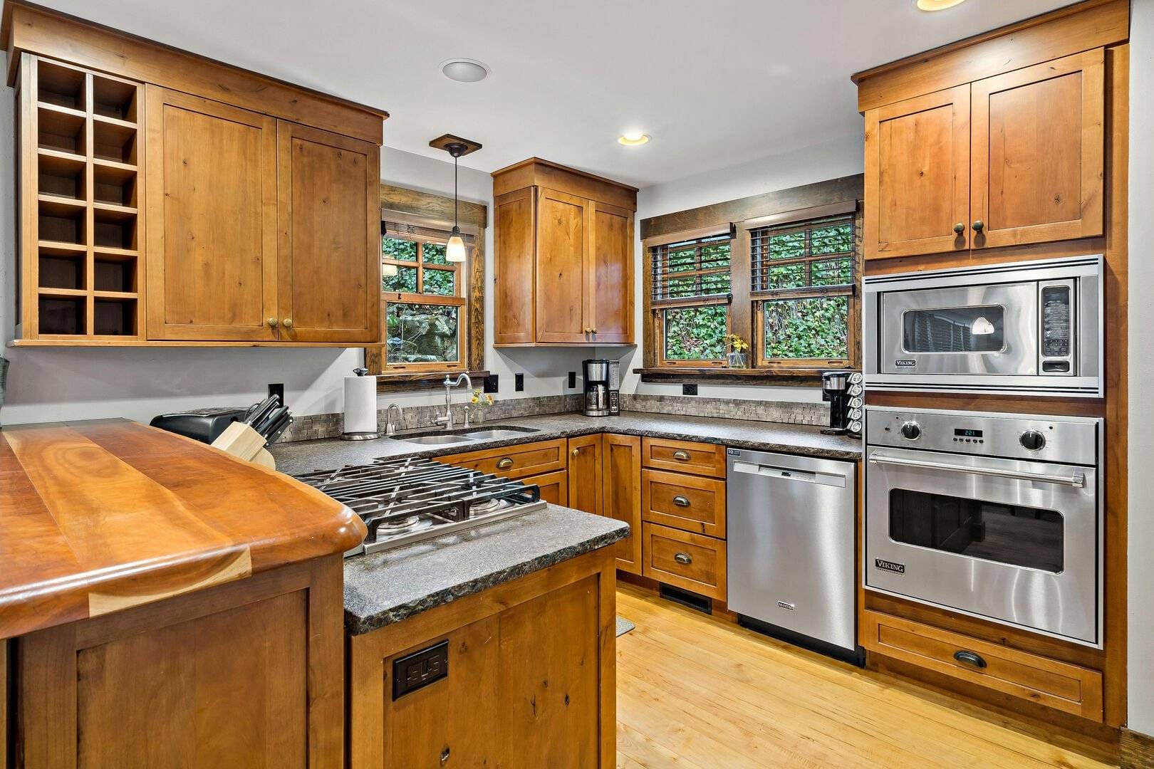 Modern wooden kitchen with appliances.