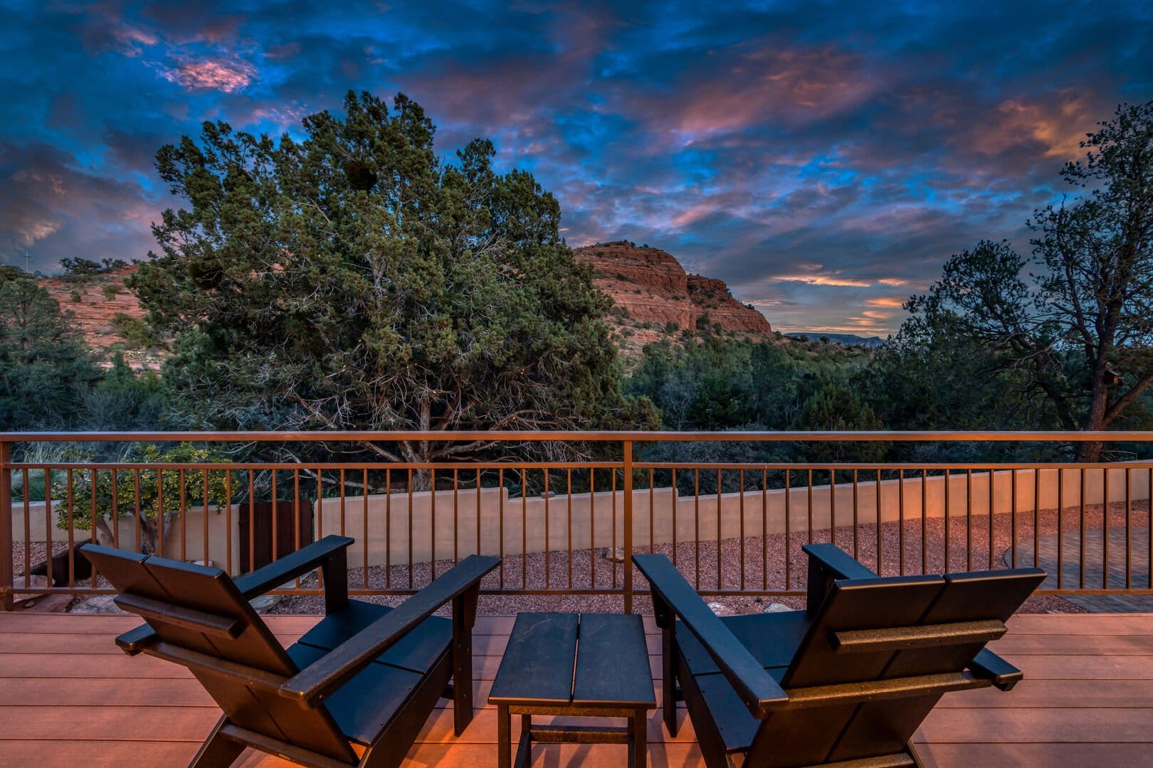 Two chairs overlooking scenic landscape.