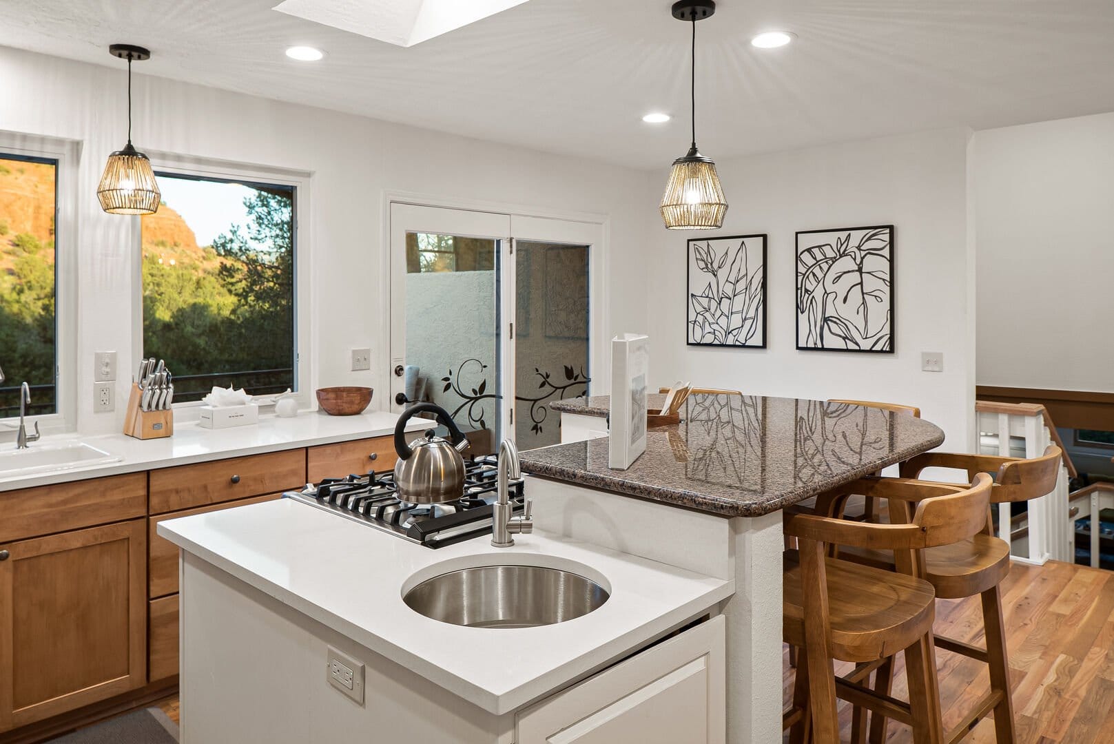 Modern kitchen with island and stools.