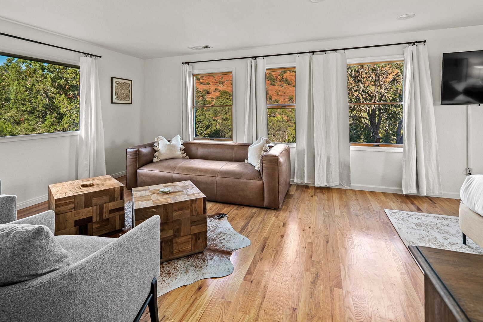 Bright living room with leather couch.