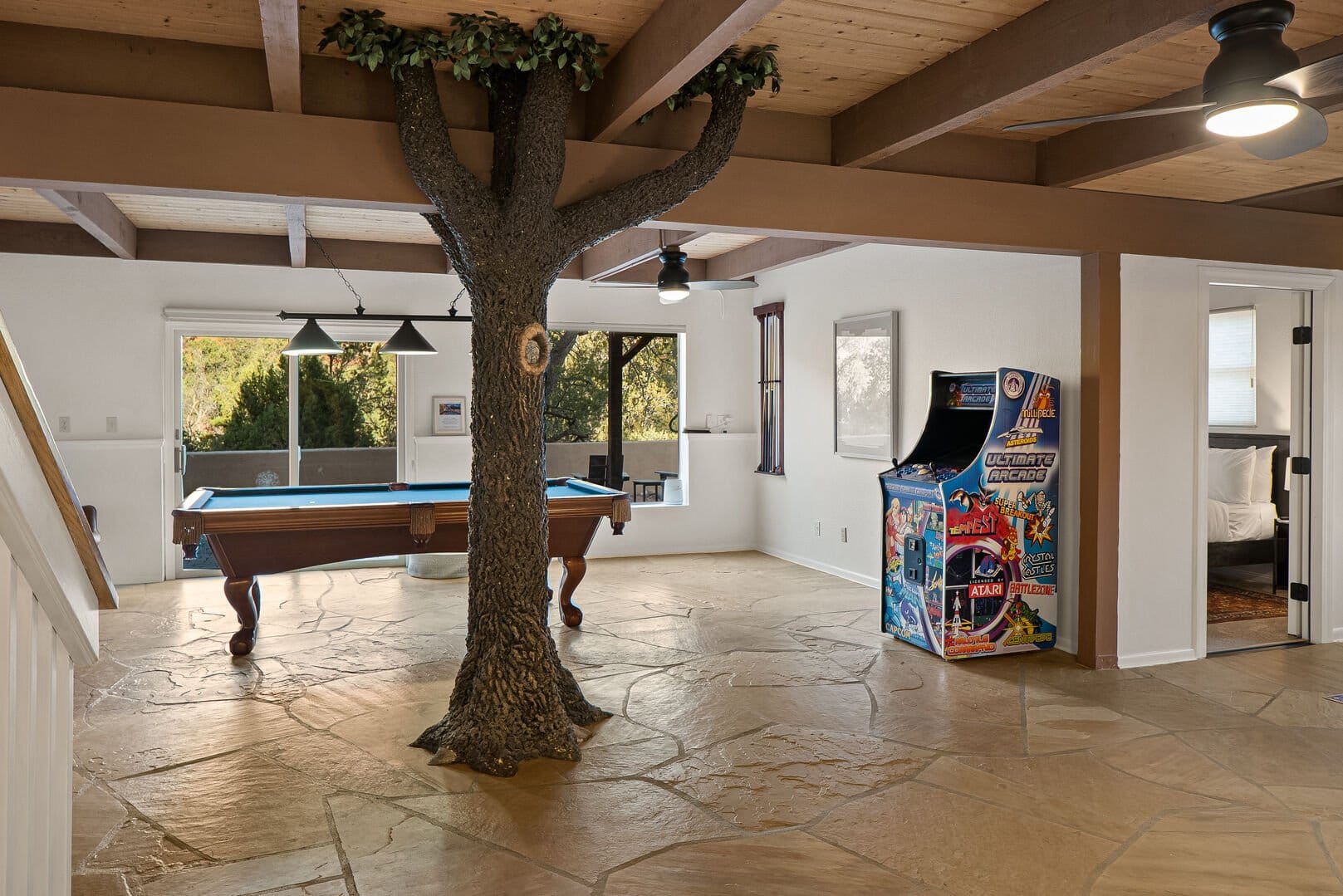 Game room with pool table, arcade.