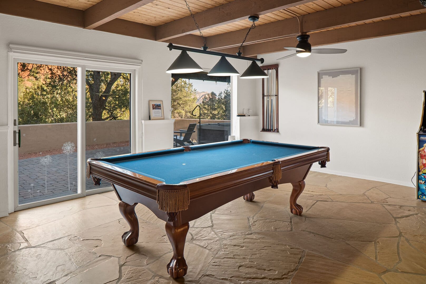 Room with pool table, windows.