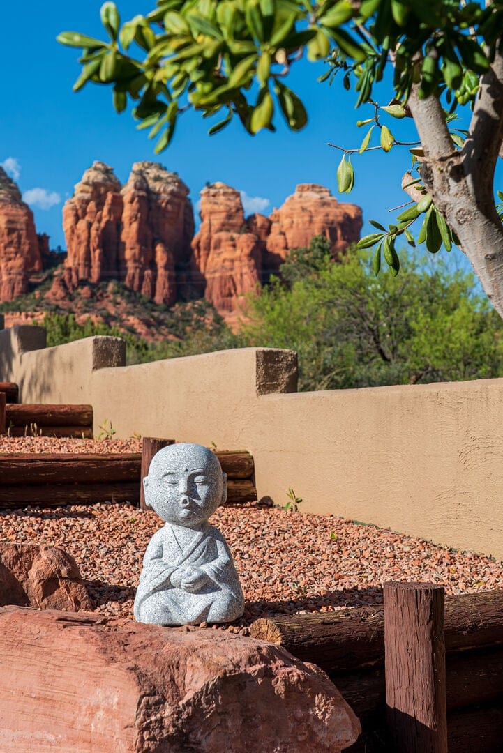 Stone statue with rock formations.