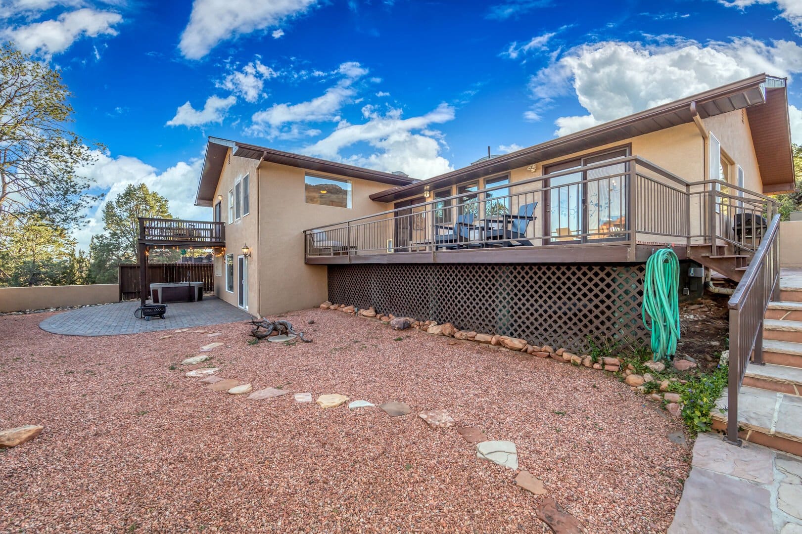 House with deck and gravel yard.