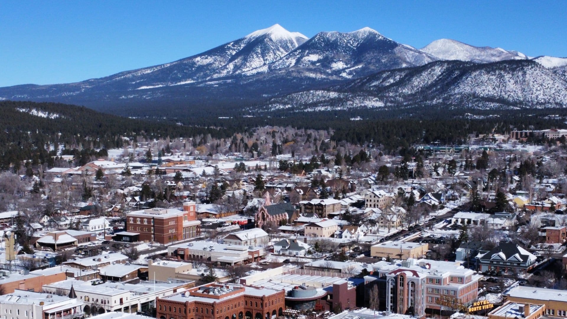 Snowy town with mountains background.