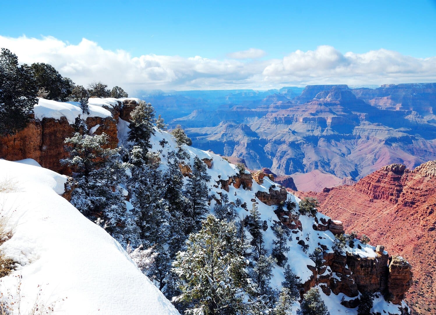 Snow-covered canyon with clear sky.