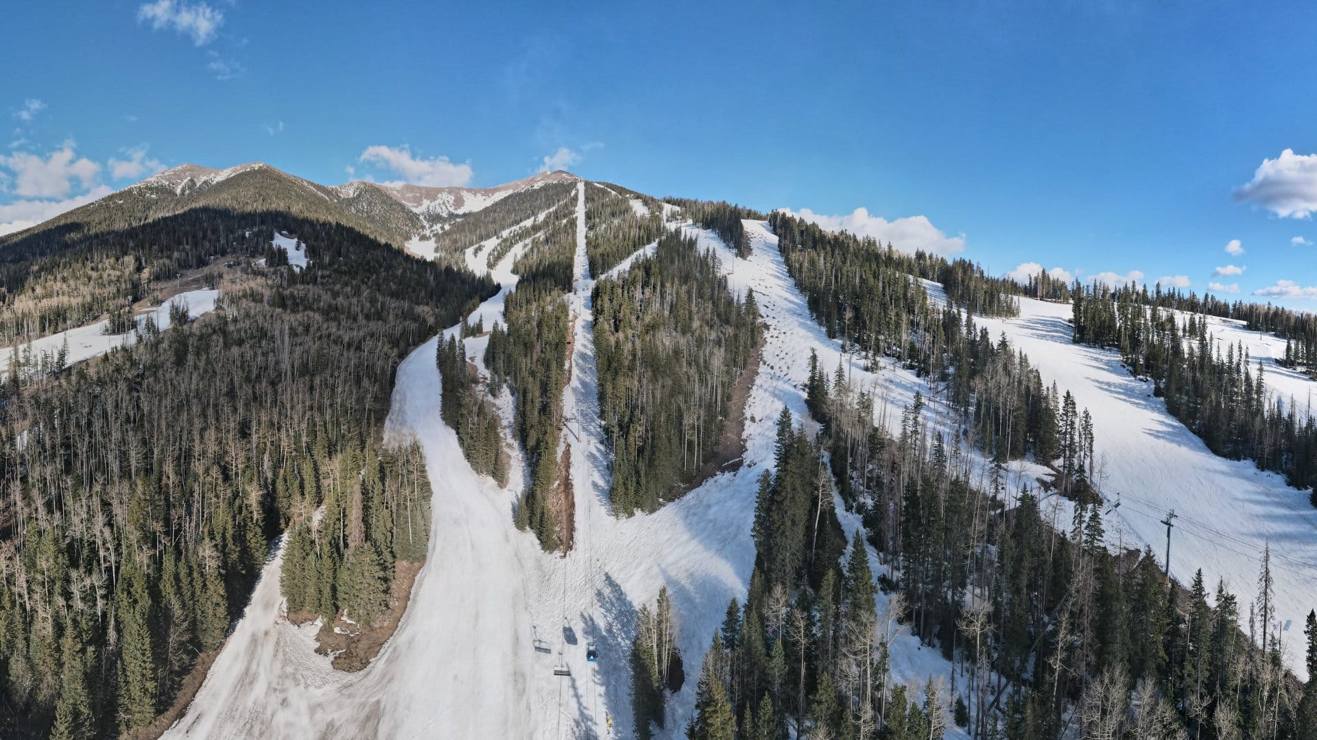 Snow-covered mountain ski slopes panorama.