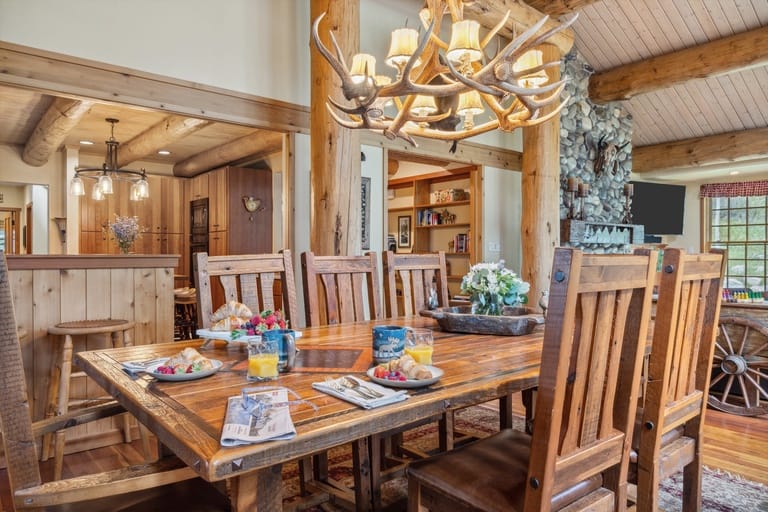 Rustic dining room with antler chandelier.